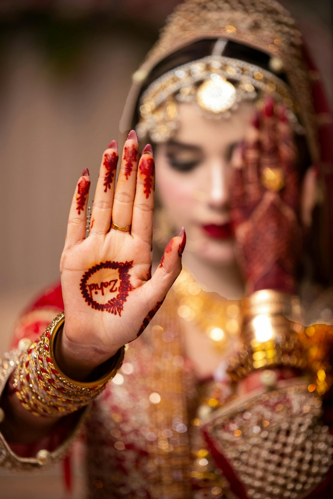 A woman in a bridal outfit holding her hands up